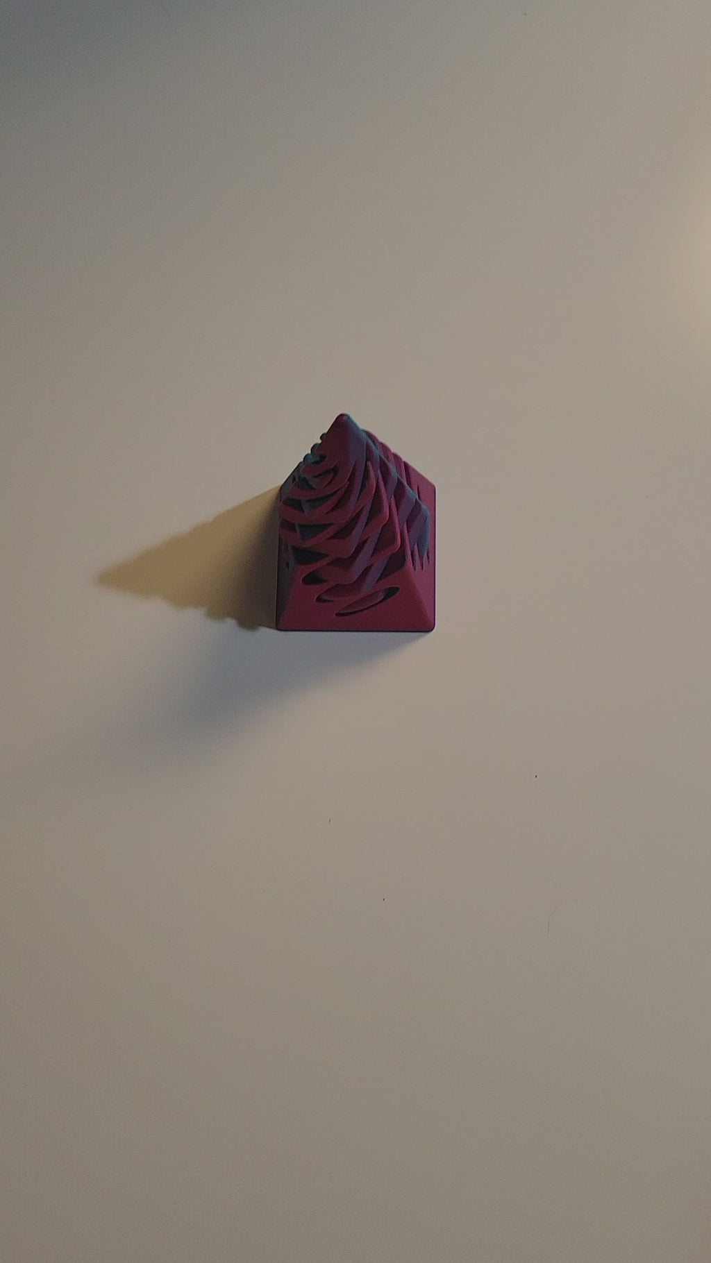 Teal to Pink color-shifting 3D-printed pyramid passthrough fidget shown twisting and passing through in all directions by 2 hands on light grey background.