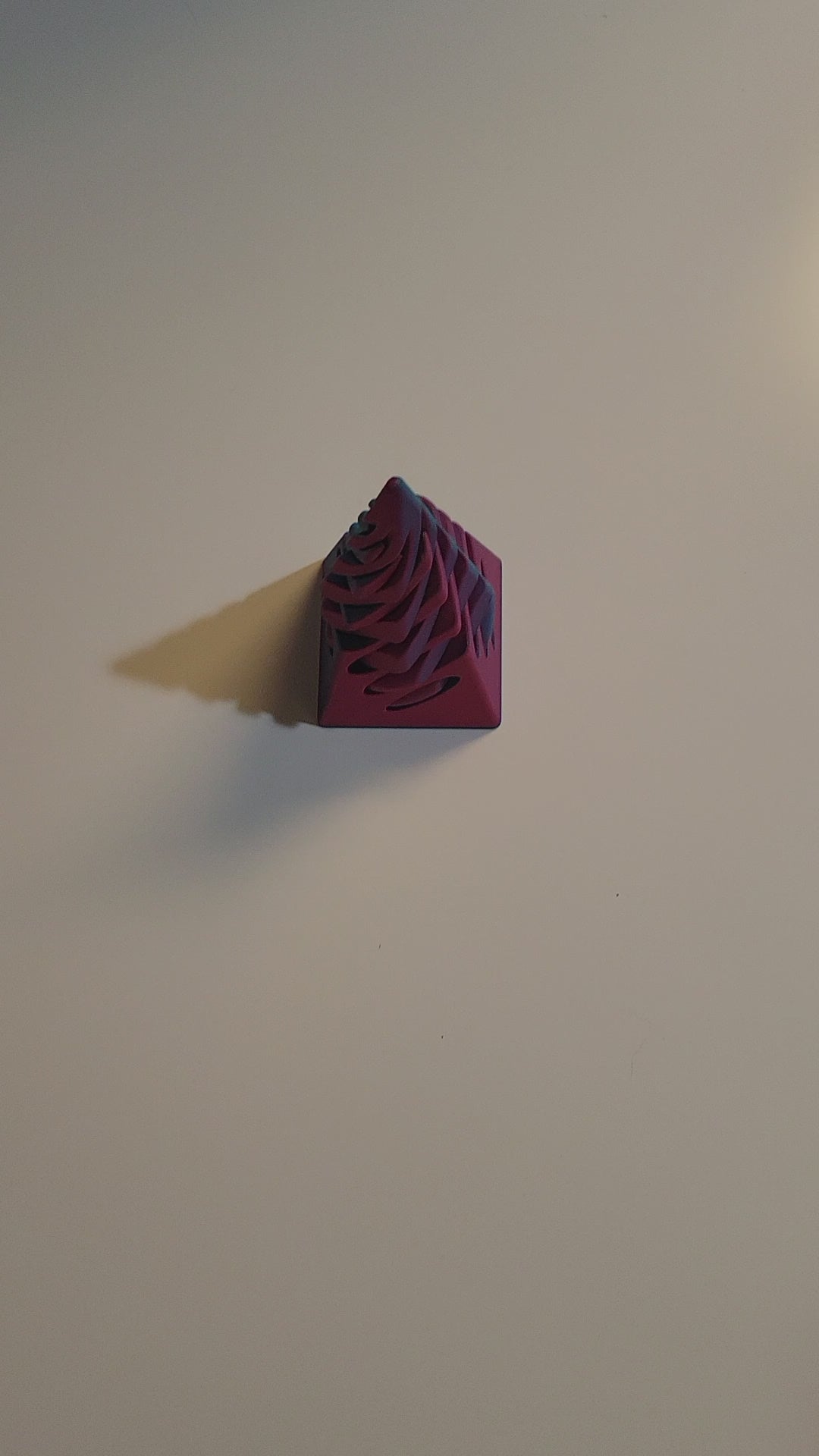 Teal to Pink color-shifting 3D-printed pyramid passthrough fidget shown twisting and passing through in all directions by 2 hands on light grey background.