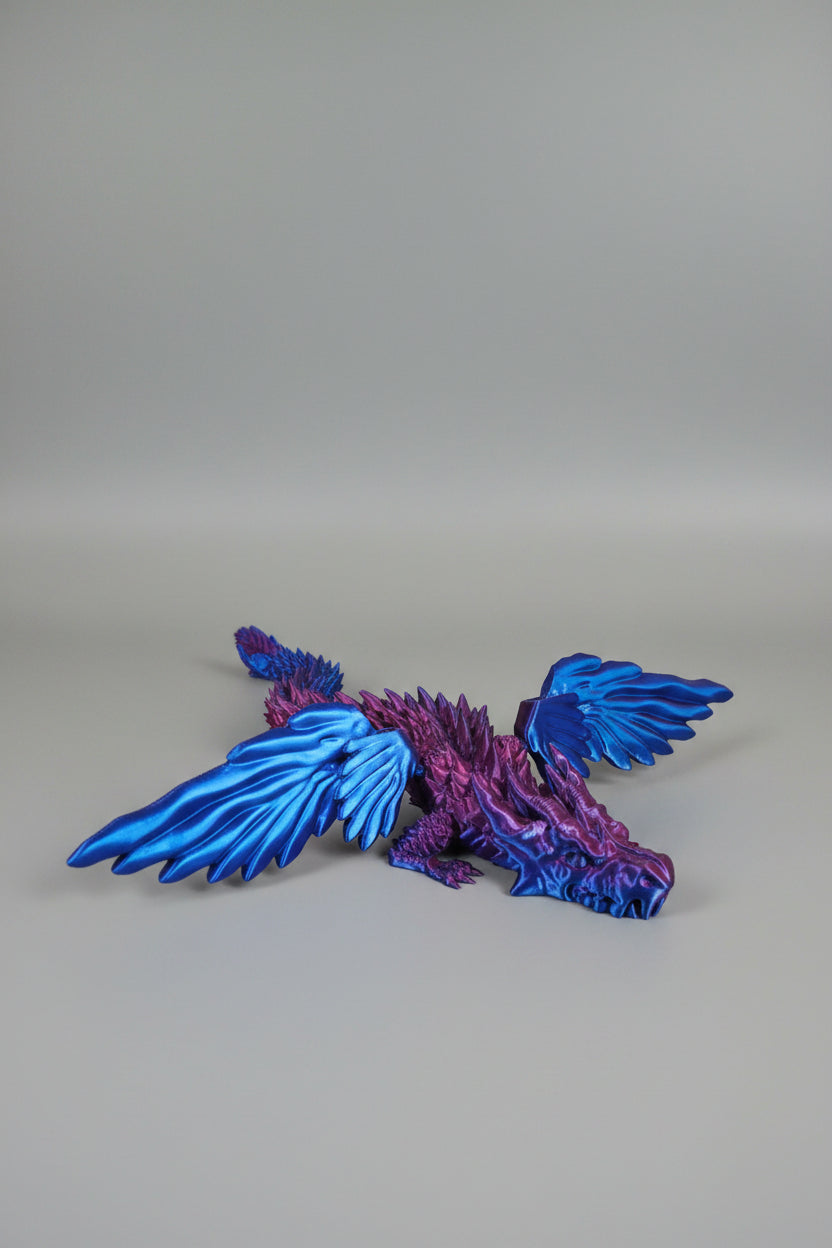 Blue to Purple Silk color-shifting 3D-printed dragon fully articulated with functional wings and jaw on a light gray backdrop.