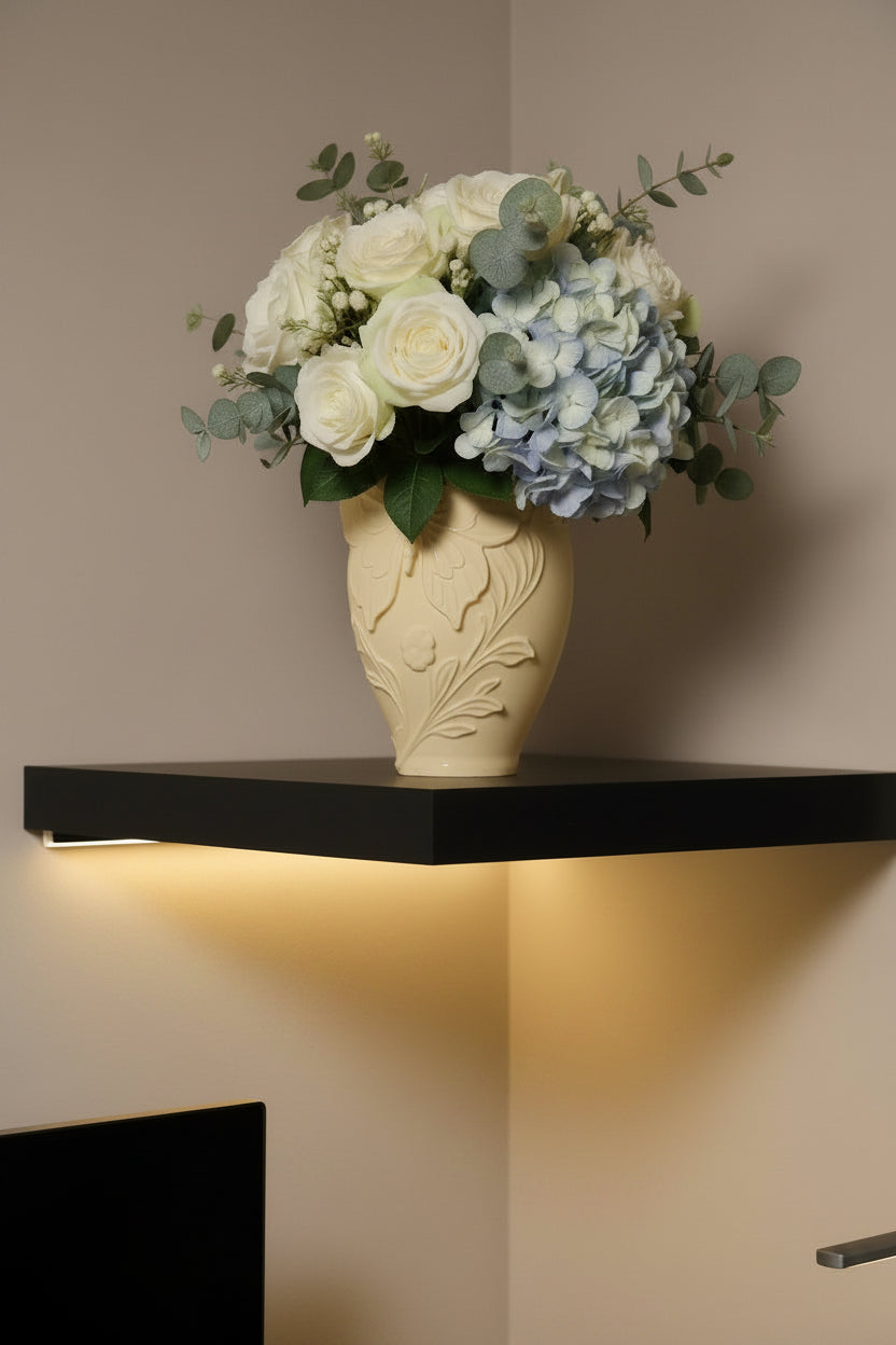 Sandstone Beige 3D-printed butterfly vase with floral and leaf designs holding blue and white flowers on a floating shelf.