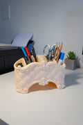 Sandstone Beige 3D-printed desk organizer with a quilted baroque design holding stationery items on a white desk.