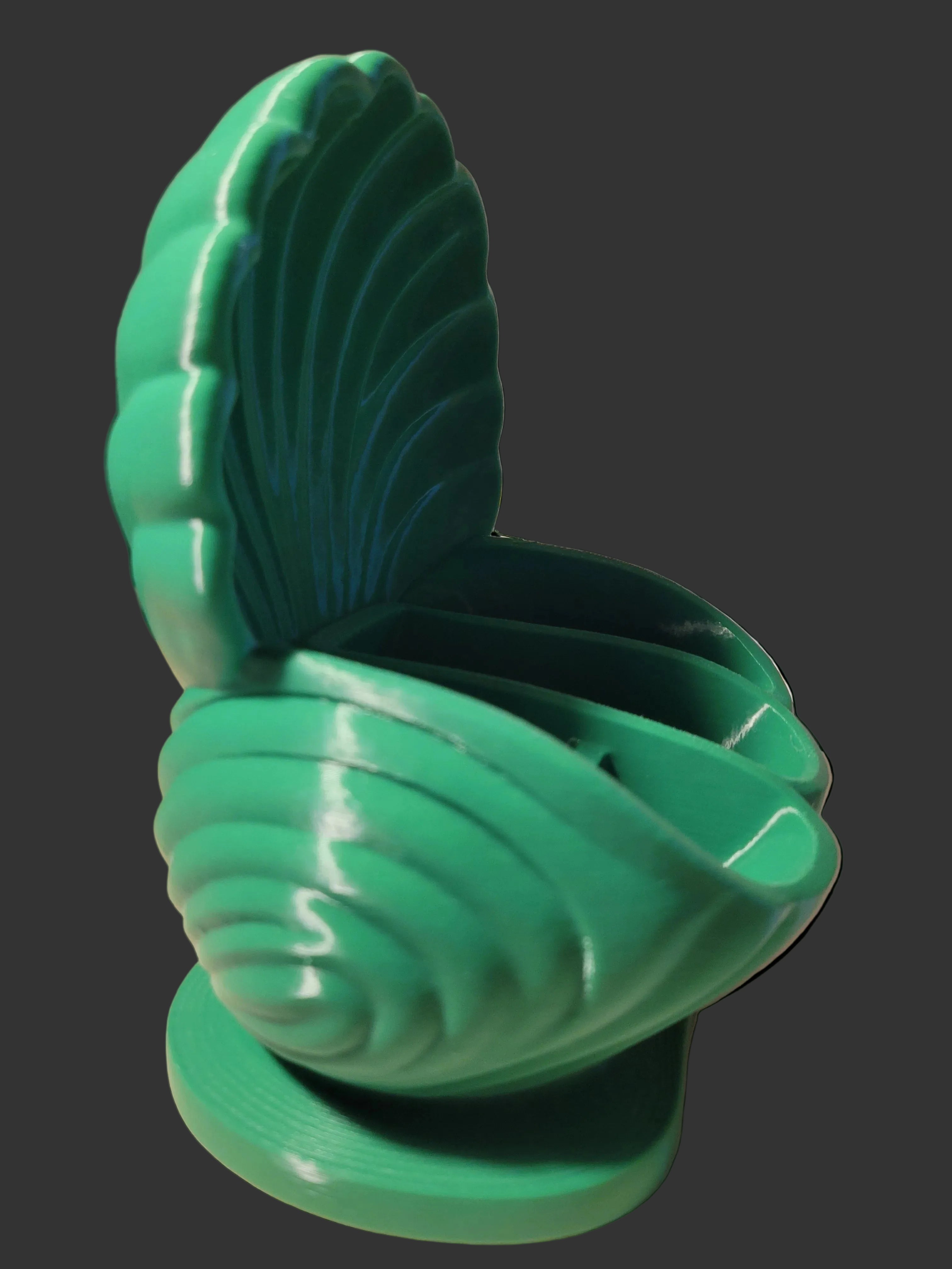 Emerald Green 3D-printed sculptured scallop inspired desktop organizer with intricate seashell design on a dark grey backdrop.