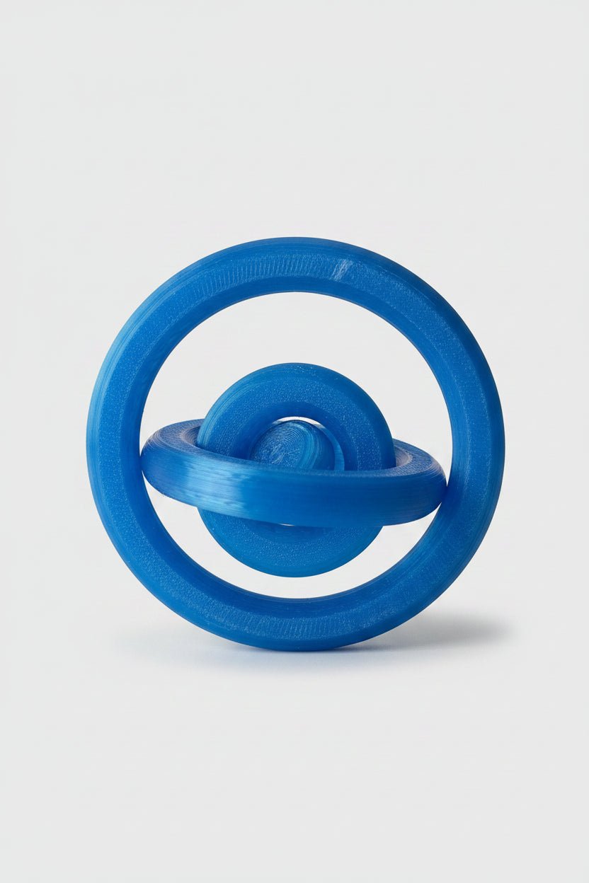 Translucent Blue 3D-printed orbital gyro desktop fidget showing staggered rings to display motion on a white background.