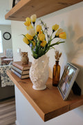 Arctic White 3D-printed vintage floral butterfly vase with handle holding yellow flowers on a shelf with other decor.