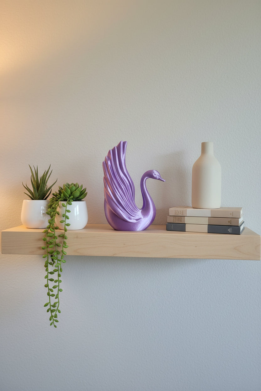 Purple Silk 3D-printed sculpture of swan elegance with detailed wing structure styled with plants and books on a shelf.