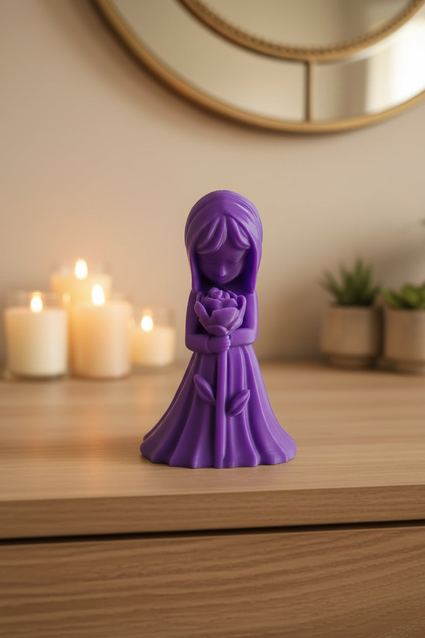 Royal Purple detailed 3D-printed girl figurine looking at a blooming rose displayed on dresser with other decor.