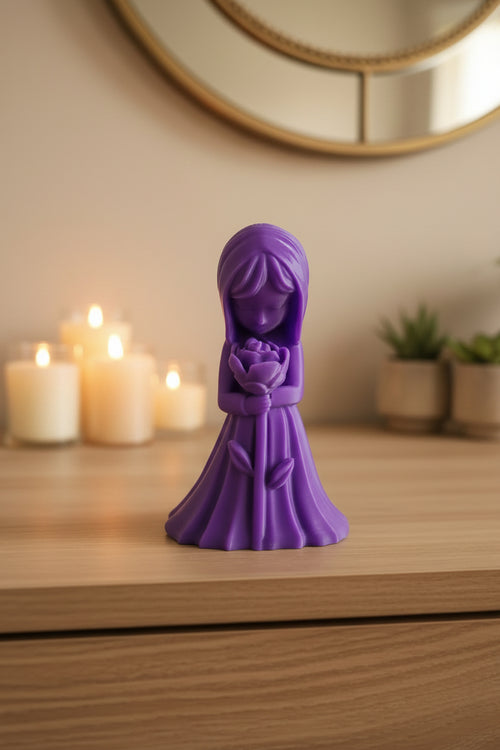 Royal Purple detailed 3D-printed girl figurine looking at a blooming rose displayed on dresser with other decor.