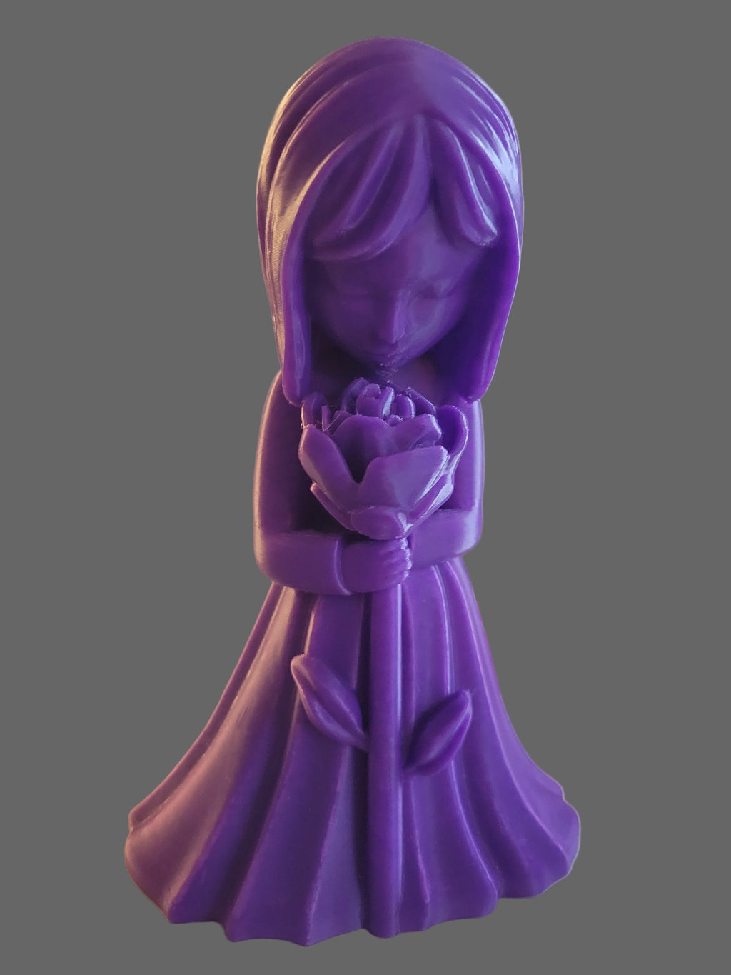 Royal Purple 3D-printed figurine of a girl in a flowing dress looking at a blooming flower on a gray background. 
