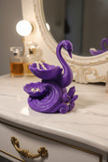 Royal Purple 3D-printed tiered jewelry organizer of an elegant swan on a wave with crystals holding a pearl necklace earring combo and a ring on white mirrored vanity with perfume.