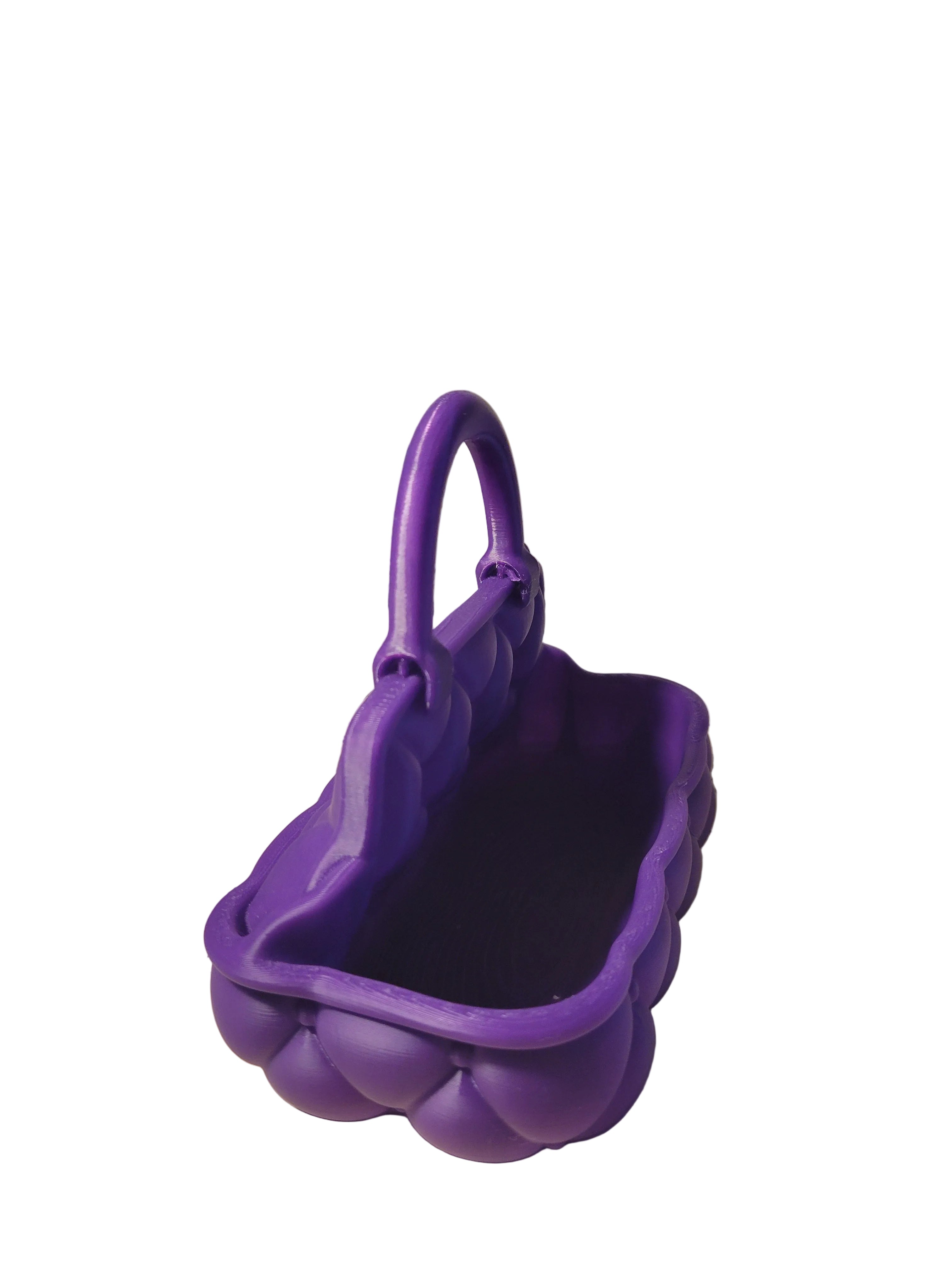 Royal Purple 3D-printed handbag catch-all design with pillow tufted detail all the way around and tote style handle on a white backdrop.
