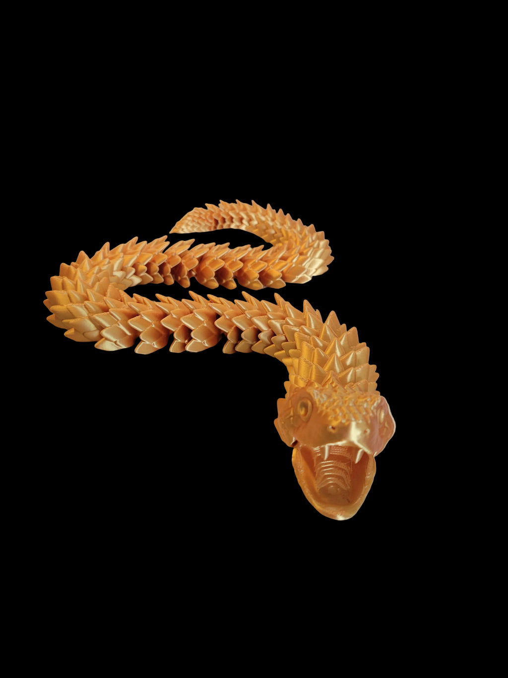 Gold Silk 3D-printed articulated viper with an open jaw showing fangs and spiky overlapping scales slithering on a black backdrop.