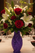 Royal Purple 3D-printed dragon vase featuring intricately embossed floral design holding flowers centered on a dining table.